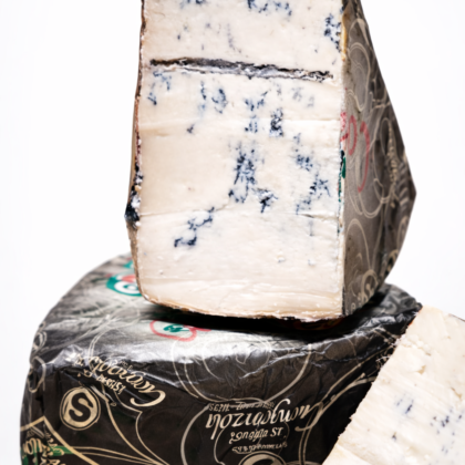 Kawałek sera Gorgonzola Piccante DOP z niebieską pleśnią